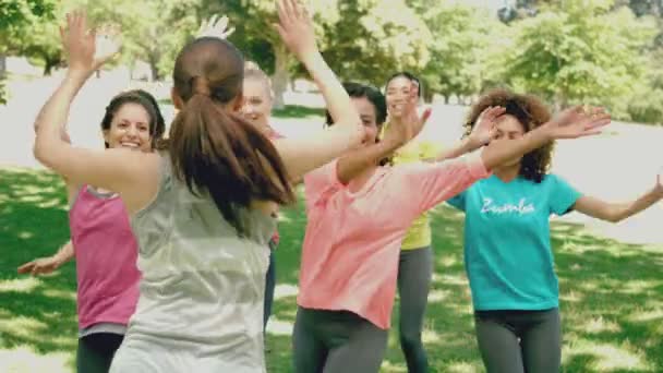 Zumba class dancing in the park — Stock Video