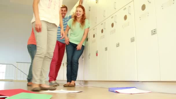 Mean students laughing at girl dropping her books — Stock Video