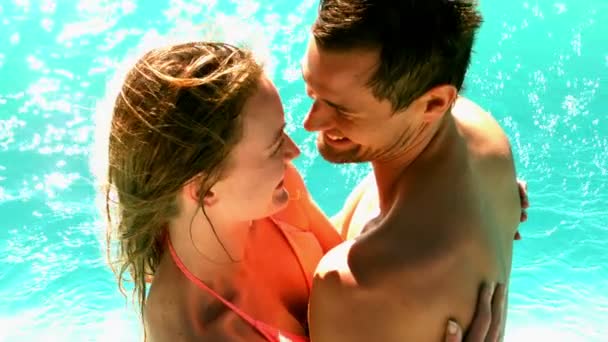 Sexy couple standing in the pool together on holidays Stock Footage