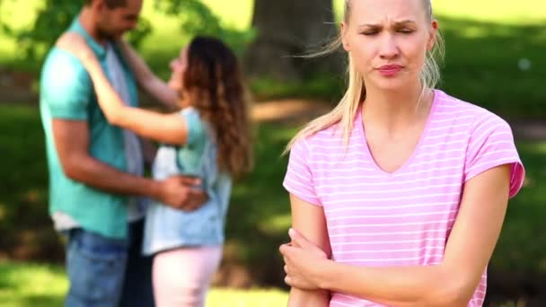 Upset girl watching her crush flirt with another girl — Stock Video