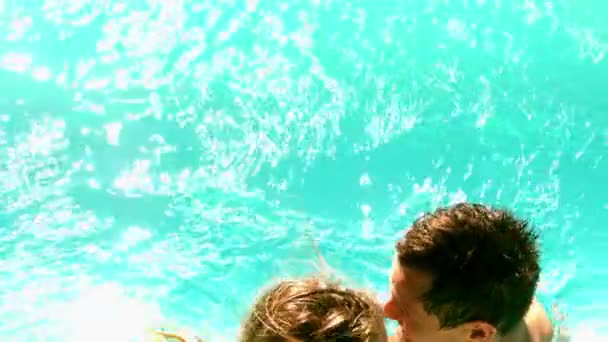 Sexy pareja zambulléndose en la piscina juntos en vacaciones — Vídeo de stock