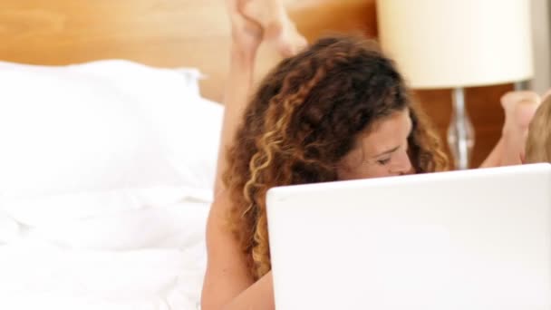 Mother and son using laptop on bed — Stock Video