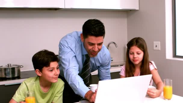 Father using the laptop with his children — Stock Video