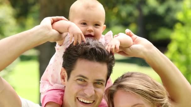 Happy parents with their baby girl in the park — Stock Video