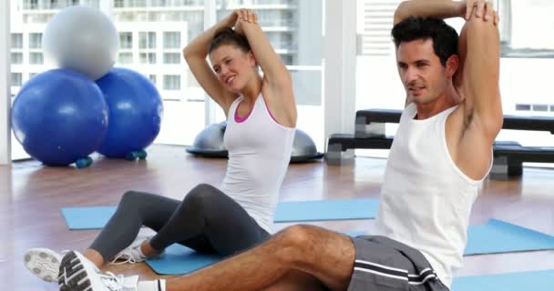 Couple étirant les bras ensemble sur le tapis d'exercice — Video