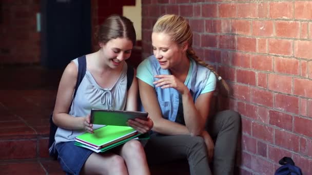 Compañeros de clase sentados en el pasillo usando tableta pc — Vídeos de Stock