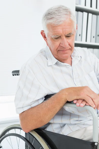 Side view of a sad senior man sitting in wheelchair — Stock Photo, Image