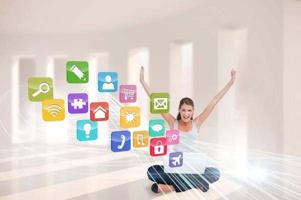Cheering blonde using laptop with app icons — Stock Photo, Image