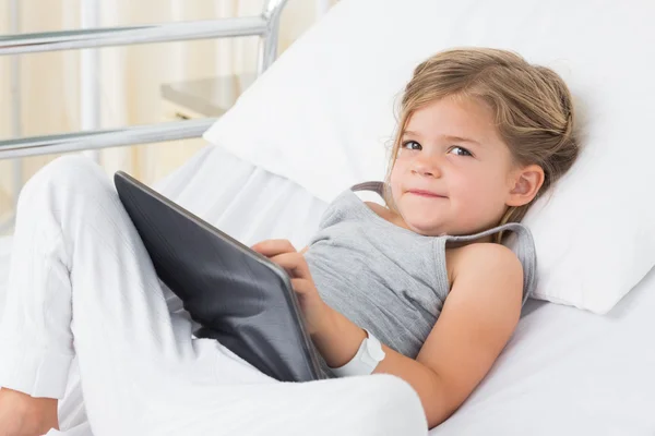 Chica con tableta digital en la cama del hospital — Foto de Stock