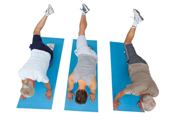 Full length of three men exercising — Stock Photo, Image