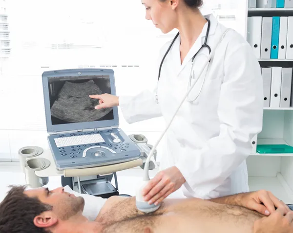 Cardiologist using sonogram on patient — Stock Photo, Image