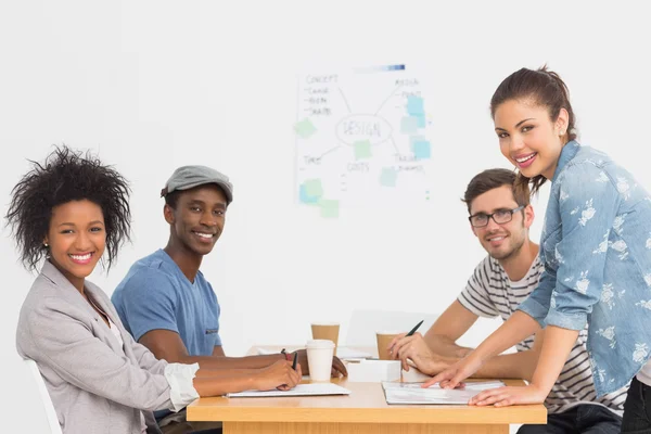 Side view of a group of artists in discussion at desk — Stock Photo, Image