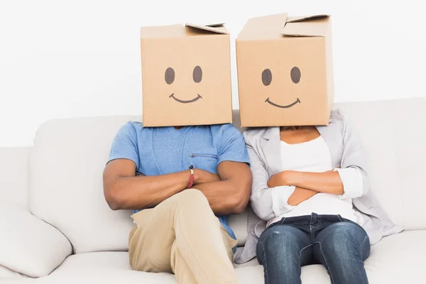 Young couple with happy smiley boxes over faces — Stock Photo, Image