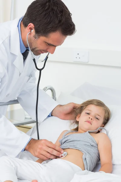 Doctor examining stomach of sick girl — Stock Photo, Image