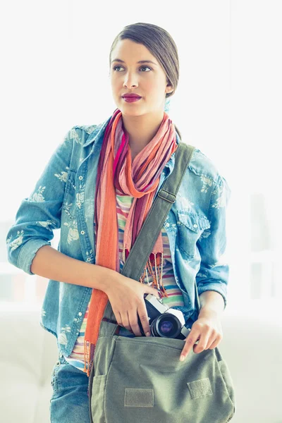 Woman taking camera from her bag — Stock Photo, Image