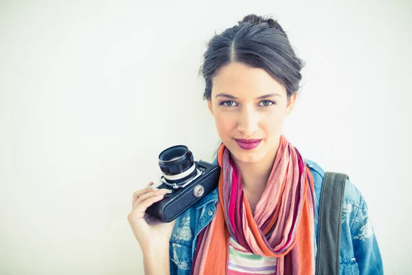 Beautiful brunette holding camera — Stock Photo, Image