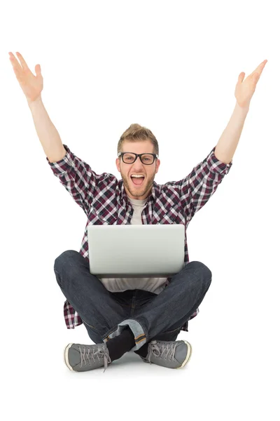 Handsome man cheering at camera with laptop — Stock Photo, Image