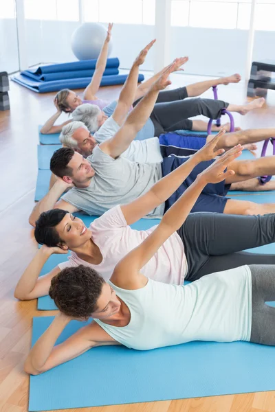 Fitness class stretching legs and hands in row — Stock Photo, Image