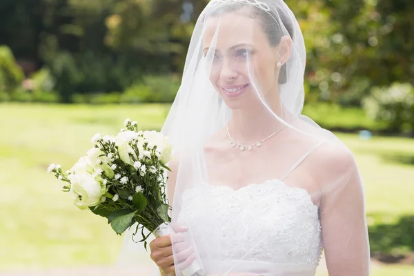 Bride looking away through veil — Stock Photo, Image