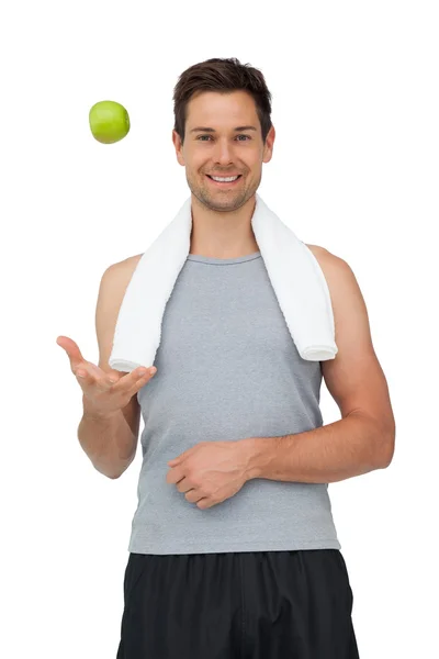 Smiling fit young man with apple — Stock Photo, Image