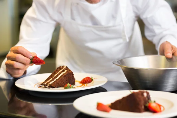 Mid section of pastry chef decorating dessert — Stock Photo, Image