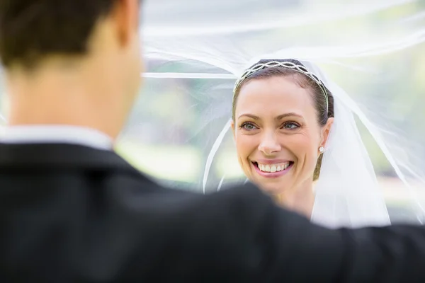 Brudgummen lyft brudslöja — Stockfoto