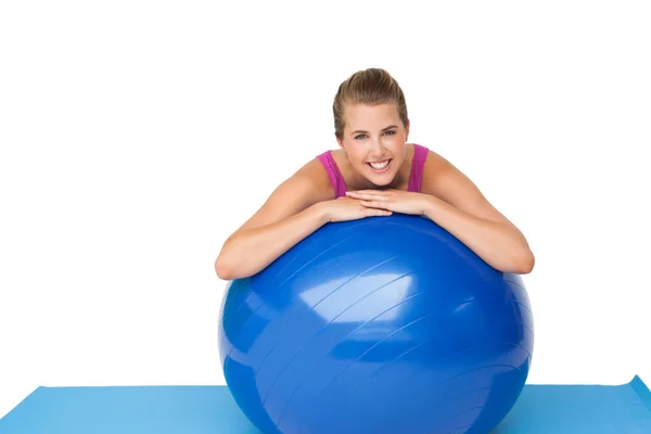 Portrait of a fit smiling woman with fitness ball Royalty Free Stock Images