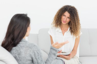 Therapist listening to her talking patient clipart