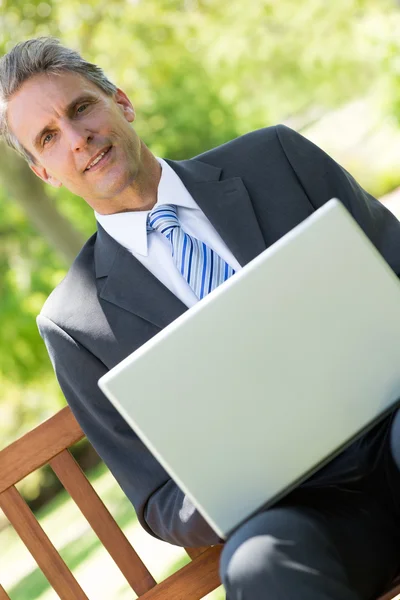 Zelfverzekerde zakenman met laptop — Stockfoto