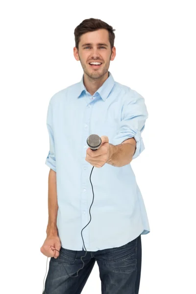 Man holding out microphone — Stock Photo, Image