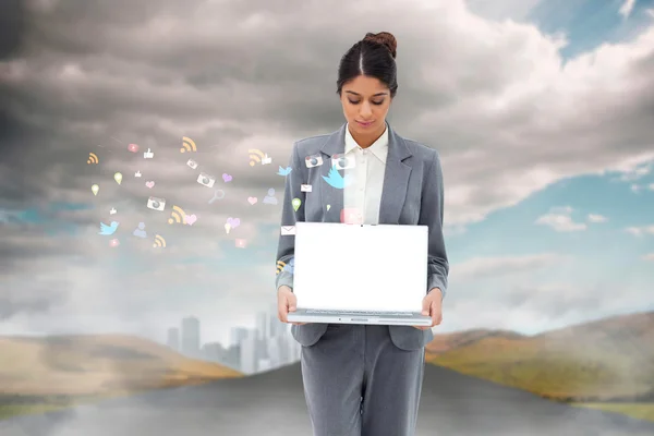 Businesswoman showing laptop with app icons — Stock Photo, Image