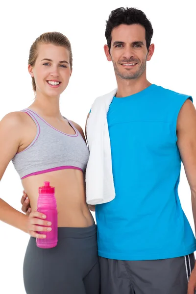 Portrait of a sporty couple with water bottle and towel — Stock Photo, Image