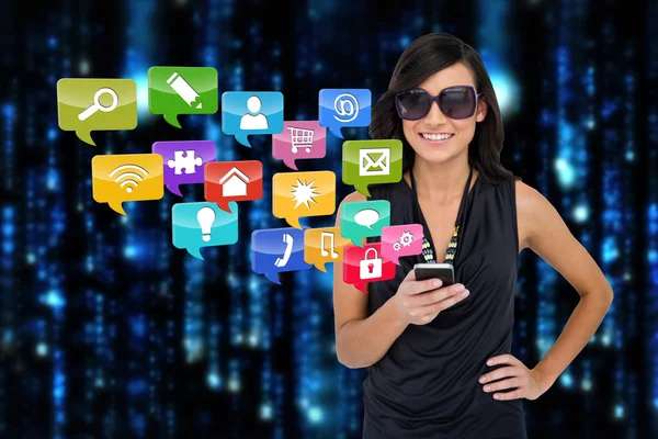 Glamorous brunette using smartphone with app icons — Stock Photo, Image