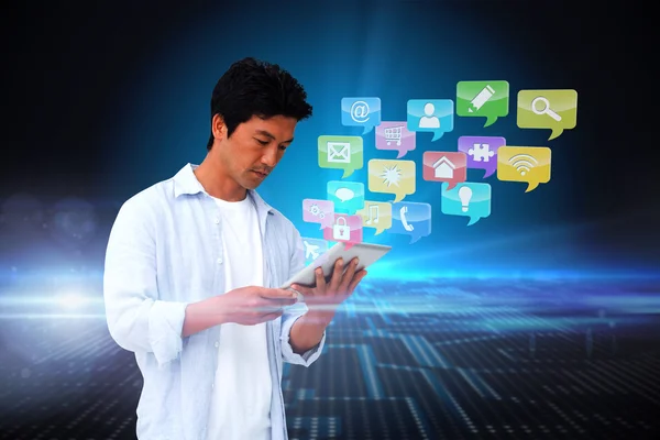 Casual man using tablet with app icons — Stock Photo, Image