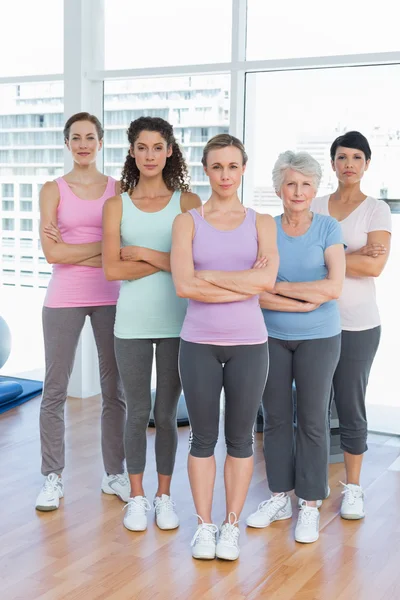 Självsäkra kvinnor med armar korsade i yogaklass — Stockfoto