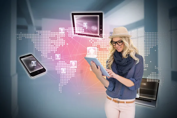 Stylish blonde using tablet pc with connecting devices — Stock Photo, Image