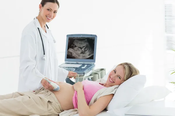 Врач с помощью ультразвукового аппарата на беременной женщине — стоковое фото