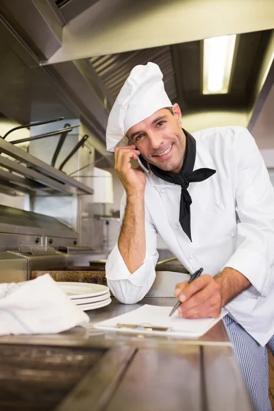 Cook writing on clipboard — Stock Photo, Image