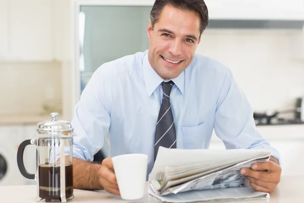 Man with coffee cup and newspaper — Stock Photo, Image