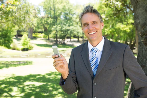 Businessman holding smart phone — Stock Photo, Image