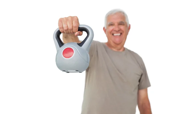 Porträtt av en äldre man som tränar med kettle bell — Stockfoto