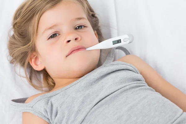 Girl with thermometer in mouth — Stock Photo, Image