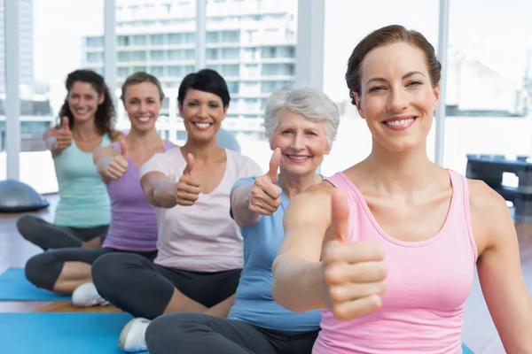 Women gesturing thumbs up in the yoga class — Stock Photo, Image