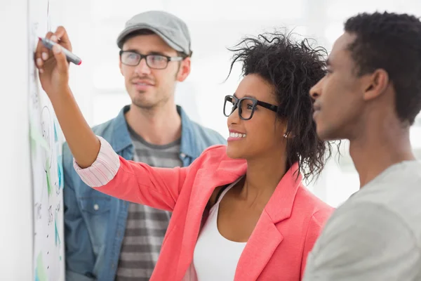 Artists in discussion in front of whiteboard — Stock Photo, Image