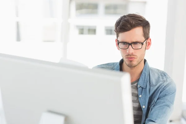 Concentrated young male artist using computer — Stock Photo, Image