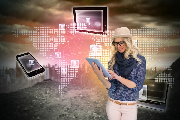 Stylish blonde using tablet pc with connecting devices — Stock Photo, Image