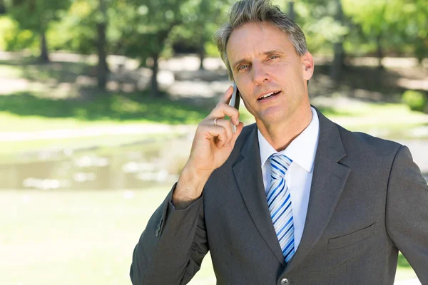Confident businessman using smart phone — Stock Photo, Image