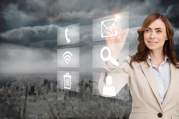 Smiling businesswoman pointing to email on app menu — Stock Photo, Image