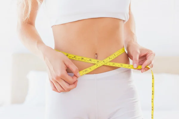 Slim woman measuring her waist — Stock Photo, Image