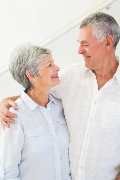 Happy retired couple standing and smiling at each other — Stock Photo, Image